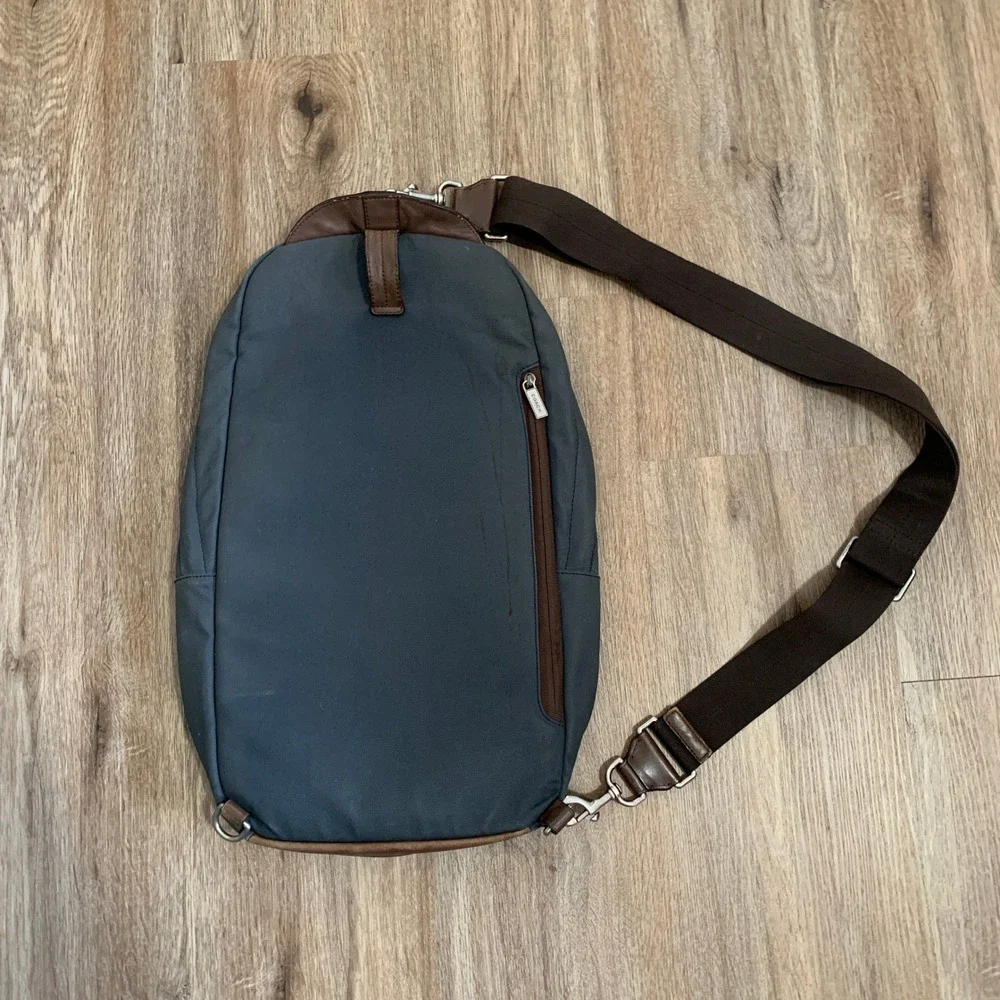 Coach 2013 canvas sling backpack in navy blue w/ brown leather panels - 13x18in‎